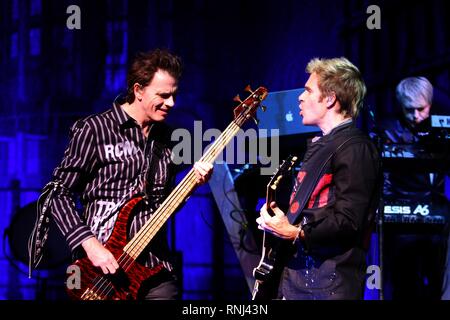 Duran Duran band members are shown performing on stage during a 'live' concert appearance. Stock Photo
