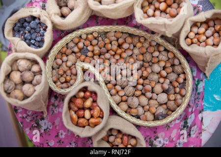 Mix of hazelnut and walnuts with hard shell . dried hazelnuts and walnuts, closeup . Hazelnuts, walnuts, nuts, and small bags in a bowl. Hazelnuts Stock Photo