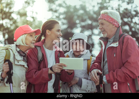 Tourists using a tablet with gps app for hiking Stock Photo