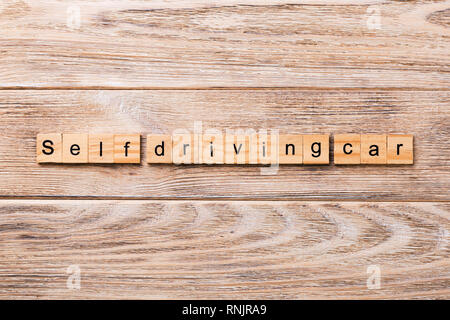 Self-driving car word written on wood block. Self driving car text on wooden table for your desing, concept. Stock Photo