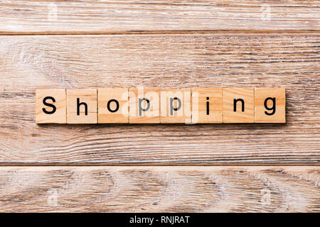 shopping word written on wood block. shopping text on wooden table for your desing, concept. Stock Photo