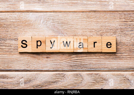 spyware word written on wood block. spyware text on wooden table for your desing, concept. Stock Photo