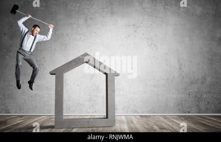 Stone home silhouette in empty room as symbol for real estae insurance Stock Photo