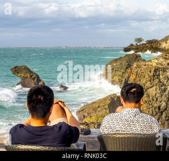 Two Chines male tourists at The Rock Bar at Ayana Resort and Spa Jimbaran Bali Indonesia. Stock Photo