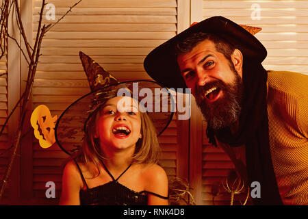 Small girl and father happy smiling on halloween. Happy family celebrate halloween. Happy father and small girl enjoy halloween party. We all go a Stock Photo