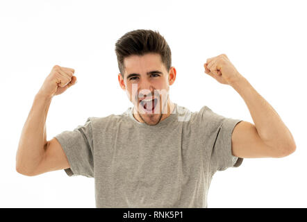 Portrait of young man celebrating achieving his goal, wining the lottery or having great success in face expression human emotions surprised and happy Stock Photo