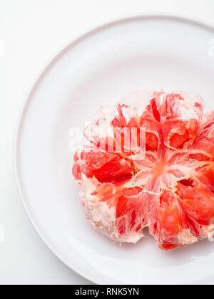 Grapefruit in plate isolated on white background. Round fresh fruit. With clipping path Stock Photo