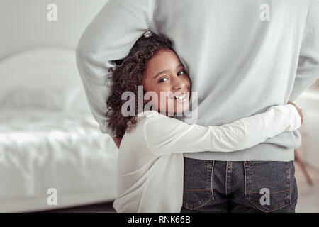 Wonderful little girl feeling very happy and protected Stock Photo