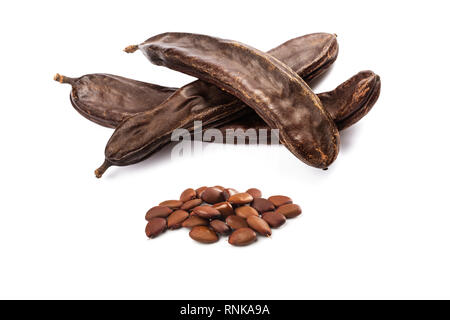 Carobs pod with beans isolated on white background Stock Photo