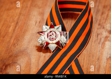 Order of the Patriotic War in St. George's Ribbon on a wooden background Stock Photo