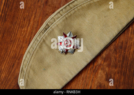 Order of the Patriotic War in St. on a Soldier's forage cap on a wooden. background Stock Photo