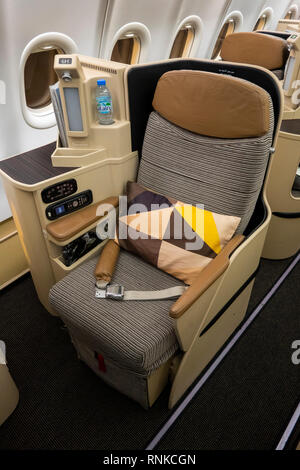 Air Travel, Etihad Airways Boeing 777-300, Business Class cabin, lie-flat bed seat for long-haul flight Stock Photo