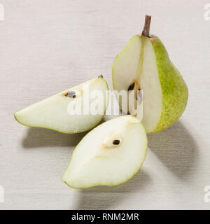 Common Pear, European Pear (Pyrus communis), Ripe fruit, halved. Studio picture against a white background Stock Photo