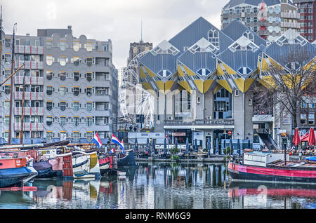 Rotterdam, The Netherlands, February 3, 2019: Historic barges in the Old Harbour against the backdrop of the famous cube houses and other architecture Stock Photo