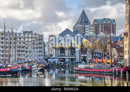 Rotterdam, The Netherlands, February 3, 2019: historic barges in and modern architecture, including the well known Cube Houses around the old harbour  Stock Photo