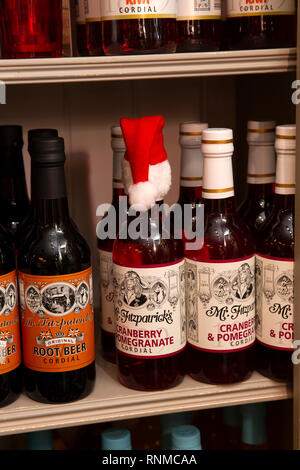 UK, England, Lancashire, Rawtenstall, Bank Street, Mr Fitzpatricks Temperance Bar, santa hat on cranberry and pomegranate cordial bottle Stock Photo