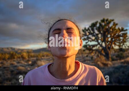 In love young pretty woman with kissing mouth, evening light, Mojave desert, desert landscape, Mojave National Preserve Stock Photo