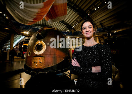 Dr. Norah Patten stands beside British astronaut Tim Peake's Soyuz TMA-19M capsule complete with equipped interior and char marks on its outer body from its re-entry into Earth's atmosphere, with the 25-metre diameter parachute used during it's high-speed descent back to Earth. The capsule and exhibition is viewable to the public at the Ulster Folk and Transport Museum in Cultra from February 20. Stock Photo