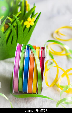 holiday background still life with multicolored ribbons on the table ready for Easter decoration Stock Photo