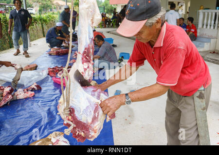 Kiulu Sabah Malaysia - Sep 24, 2015 : Muslim man butchers trimming a buffalo cow to be distributed to muslims in needs during Eid Al-Adha Al Mubarak o Stock Photo