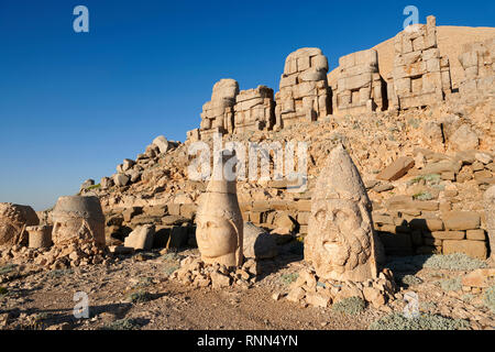 Statue heads, from right, Herekles, Apollo & Zeus, with headless seated statues in front of the stone pyramid 62 BC Royal Tomb of King Antiochus I The Stock Photo