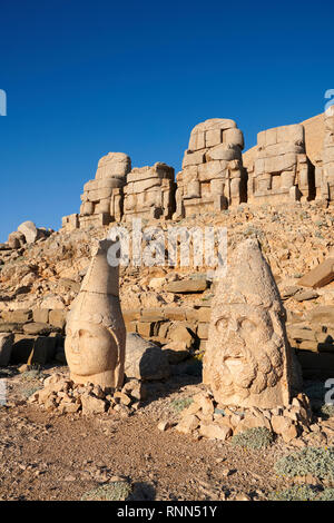 Statue heads, from right, Herekles & Apollo with headless seated statues in front of the stone pyramid 62 BC Royal Tomb of King Antiochus I Theos of C Stock Photo