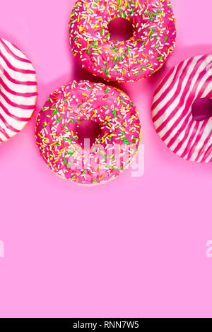Donuts on a pink background. Delicious dessert. Stock Photo