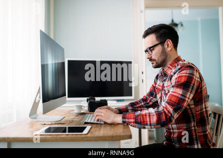 Young designer working on project at home Stock Photo