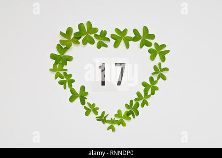Number 17 to celebrate St Patrick's Day in green heart frame from clover leaves, isolated on white background Stock Photo