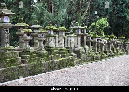 Nara, Japan (Kansai region) - old city on UNESCO World Heritage Site. Old mossy stone lanterns on the way leading to Kasuga Shrine. Stock Photo