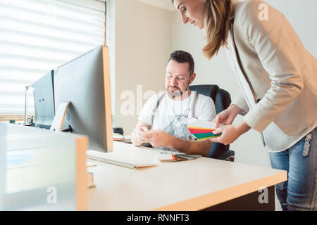 Creatives working in team checking colors for advertising project Stock Photo