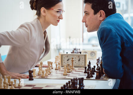Concept of confrontation, businesspeople playing chess Stock Photo
