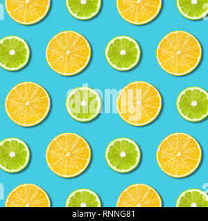 Vibrant lemon and green lime slices pattern on turquoise color background. Minimal flat lay top view food texture Stock Photo