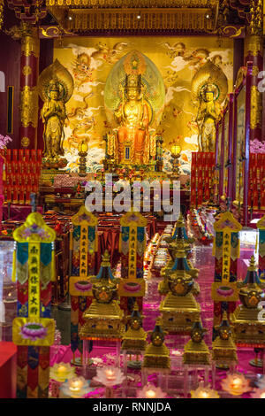 Singapore Buddha Tooth Relic Temple.  Buddha Maitreya Flanked by Two Bodhisattvas in Main Prayer Hall. Stock Photo