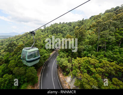 A Skyrail gondola going over the road in the Kuranda Range, Cairns, Far North Queensland, FNQ, QLD, Australia Stock Photo