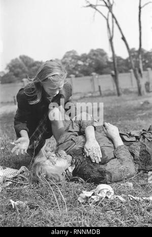 Kazimiera Mika, a 12 years old Polish girl, mourns the death of her older sister Andzia (14), who was killed in a field near Jana Ostroroga Street in Warsaw during a German air raid by Luftwaffe. Stock Photo