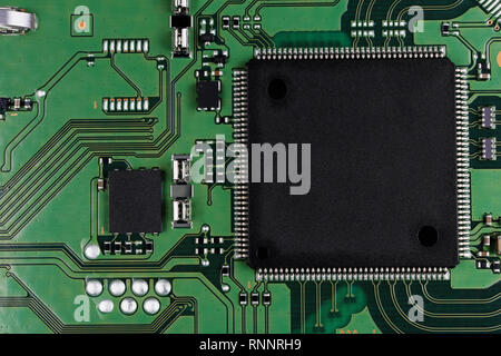 Microchips and microcircuits are installed on a modern electronic circuit board.  Mass production. Super macro studio concept Stock Photo
