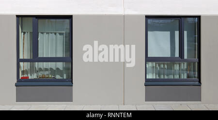 Two closed warm plastic windows in a modern residential building. Sunny April spring day panoramic concept Stock Photo