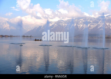 Srinagar, Jammu and Kashmir, India. 19th Feb, 2019. Kashmiri boatman seen rowing his boat near fountains on Dal Lake during a sunny day in Srinagar.Kashmir has been divided between India and Pakistan since their partition and independence from Britain in 1947. The disputed region is claimed in full by both sides, which have fought three wars over it. Credit: Idrees Abbas/SOPA Images/ZUMA Wire/Alamy Live News Stock Photo