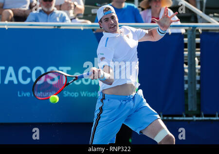 Delray Beach, Florida, USA. 19th Feb, 2019. John Isner, of the United States, returns the ball to Peter Polansky, of Canada, during the first round of the 2019 Delray Beach Open ATP professional tennis tournament, played at the Delray Beach Stadium & Tennis Center in Delray Beach, Florida, USA. Mario Houben/CSM/Alamy Live News Stock Photo