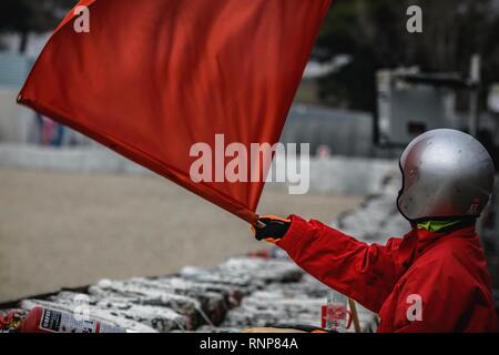 Barcelona, Spain. 20th Feb, 2019. A marshal waves a red flag during day three of the Formula One winter testing at Circuit de Catalunya Credit: Matthias Oesterle/Alamy Live News Stock Photo