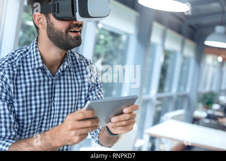 Business person using virtual reality headset holding digital tablet Stock Photo