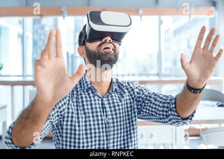Business person using virtual reality headset joy Stock Photo