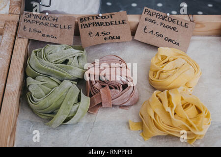 Variety of fresh artisan pappardelle pasta on sale at a street market. Stock Photo