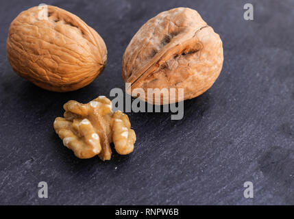 Walnuts on black surface Stock Photo