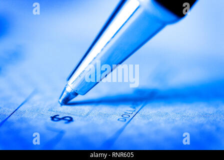 Signing a Check for Personal Finances Stock Photo