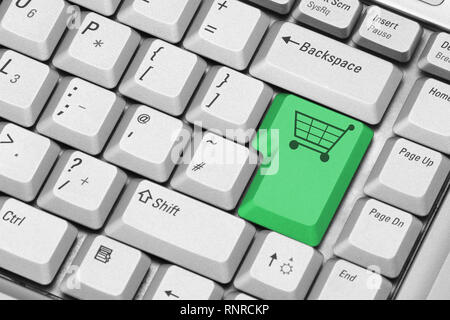 a computer keyboard with shopping cart key in green Stock Photo