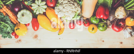 Fresh farm produce, organic vegetables on wooden pine table, healthy background, copy space for text, top view, selective focus Stock Photo