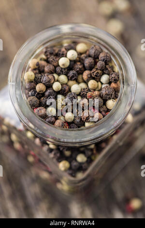 Different types of dried peppercorn in jar. Stock Photo