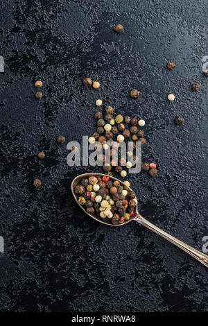 Different types of dried peppercorn in spoon. Stock Photo